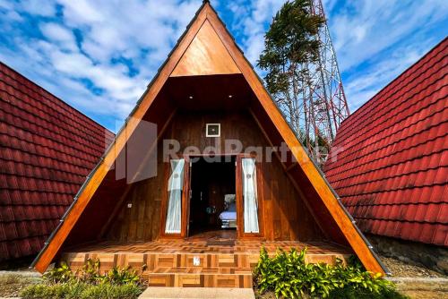 a small house with a red roof at Glamping Pengilon Edupark Mitra RedDoorz in Temanggung
