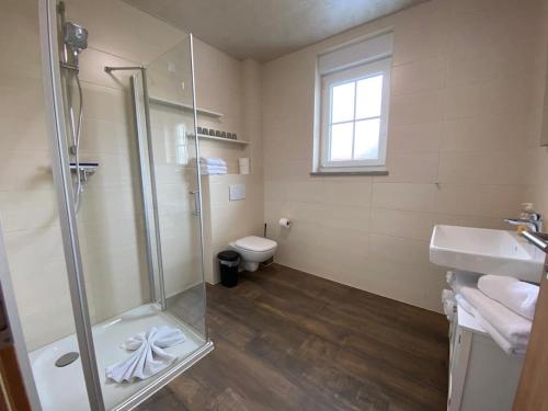 a bathroom with a shower and a sink and a toilet at Marianna Apartments Weimer in Rust