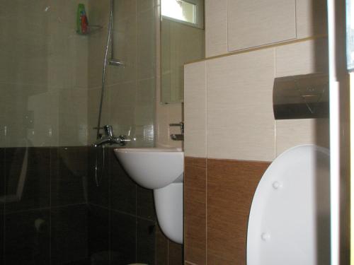 a bathroom with a white toilet and a sink at BLOCK 531 ApartHouse BLOCK 533 in Sofia