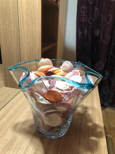 a glass bowl filled with seashells on a table at Σταματάκης in Sitia