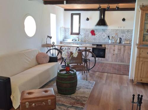 a living room with a couch and a kitchen at Holiday Home Nadira in Erdut