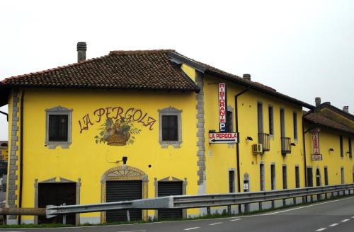 a yellow building with graffiti on the side of a road at La Pergola in Zibido San Giacomo