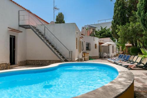a swimming pool in front of a house at Villa Minerva by Sealand Villas in Alcudia