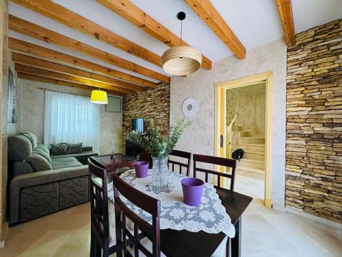 a dining room with a table and chairs and a couch at Casa Familiar- Residencial Solmar in Sanlúcar de Barrameda