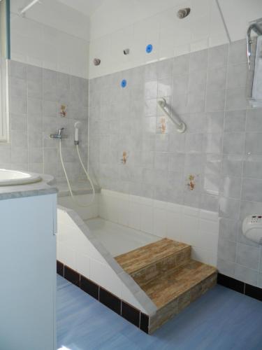 a bathroom with a tub and a shower and a sink at Le Clos Des Dryades d in Vers