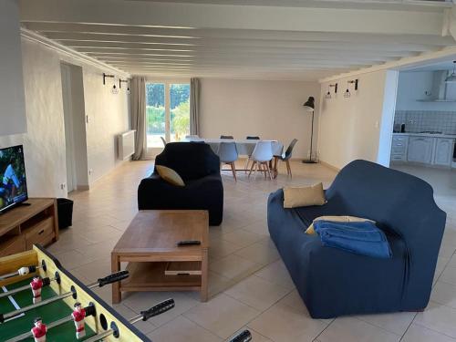a living room with a blue couch and a table at Gite de Morlannes - Nogaro, Barbotan in Marguestau