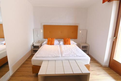 Postel nebo postele na pokoji v ubytování Hotel Da Tino
