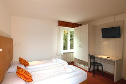 Postel nebo postele na pokoji v ubytování Hotel Da Tino