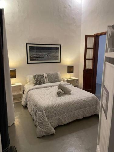 a bedroom with a large bed and two lamps at Villa Mia in Trou d'Eau Douce