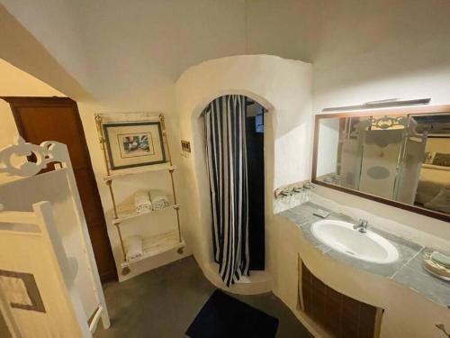 a bathroom with a sink and a mirror at Villa Mia in Trou d'Eau Douce