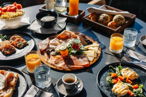a table topped with plates of food and drinks at Bevanda Hotel & Restaurant - Unique Adriatic in Opatija