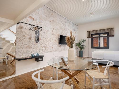 a living room with a glass table and chairs at Faedra Residence in Chania Town
