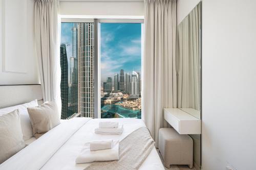a hotel room with a view of a city at Luxury 4BR Burj Khalifa & Fountain Views in Dubai