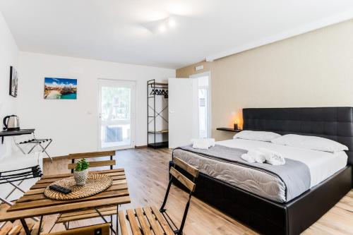 a bedroom with a large bed and a table at Pietramare Luxury Suites in Bari