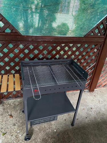 a barbecue grill sitting in front of a fence at Casa Jeni in Suceava