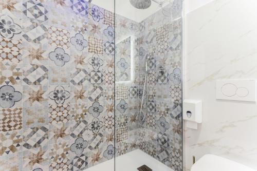 a bathroom with a shower with a glass door at Pietramare Luxury Suites in Bari