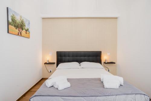 a bedroom with a large white bed with two lamps at Pietramare Luxury Suites in Bari