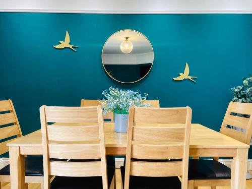 a dining room with a wooden table and a mirror at Escape Ordinary at Castle Hume in Enniskillen