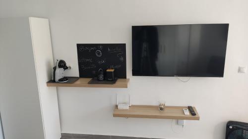 a flat screen tv hanging on a wall at Loft La Cala de Mijas beach estudio mirando al mar in La Cala de Mijas