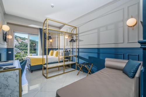a bedroom with blue walls and a bed with a mirror at Hotel Mary in Vico Equense