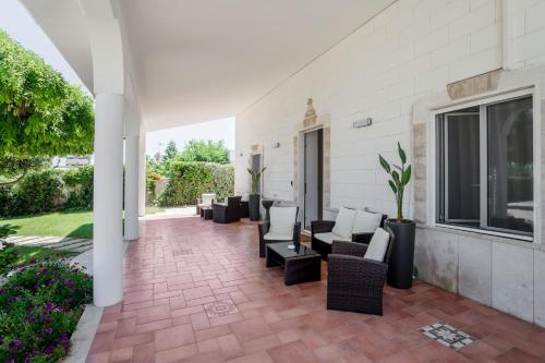 a patio with couches and chairs on a house at Pietramare Luxury Suites in Bari