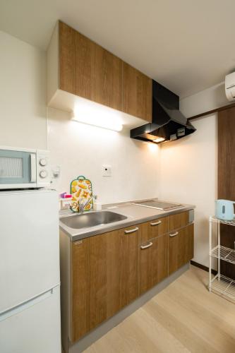 a kitchen with a sink and a refrigerator at 22, Itabashi, Entire house for rent, 板橋 in Tokyo