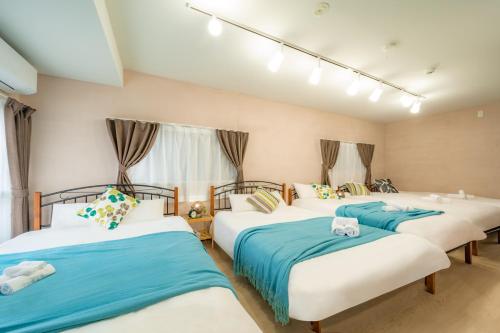 three beds in a room with blue and white at 22, Itabashi, Entire house for rent, 板橋 in Tokyo