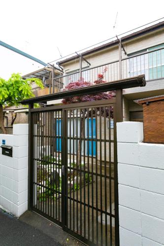 a black gate in front of a building at 22, Itabashi, Entire house for rent, 板橋 in Tokyo