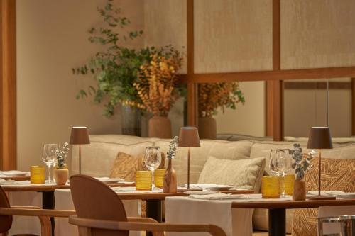 a dining room with tables and chairs and a couch at PortoBay Liberdade in Lisbon