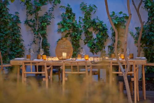 a long wooden table with chairs and wine glasses at PortoBay Liberdade in Lisbon