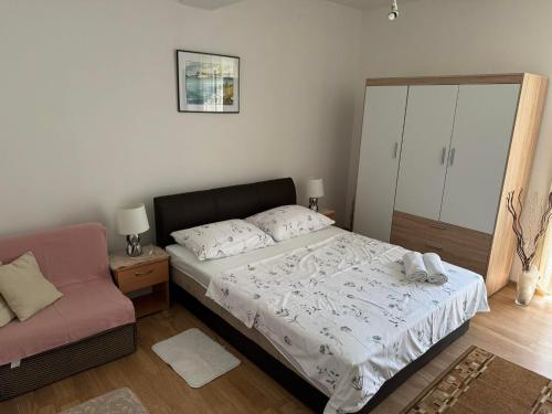 a bedroom with a bed and a chair at Apartment Teo & Leon in Novi Vinodolski