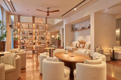 a restaurant with white chairs and a table andools at PortoBay Liberdade in Lisbon