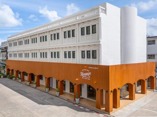 a white building with an orange and white facade at Horange Phuket Town in Phuket