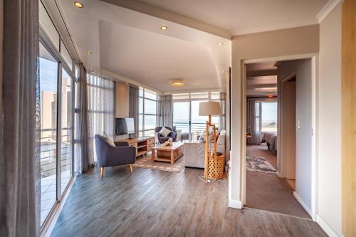 a living room with a view of a living room at Luxury Ocean View Beachfront 2 bed apartment -206 The Waves, Blouberg, Cape Town in Bloubergstrand