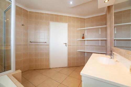 a bathroom with a shower and a sink at Luxury Ocean View Beachfront 2 bed apartment -206 The Waves, Blouberg, Cape Town in Bloubergstrand