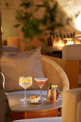 a table with two drinks on top of a table at PortoBay Liberdade in Lisbon