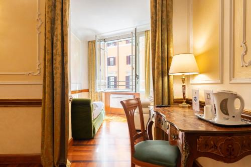 a room with a desk and a chair and a window at Hotel Hiberia in Rome