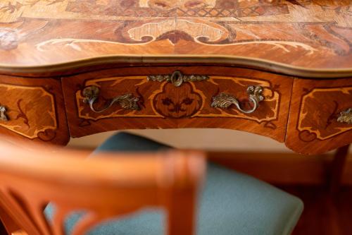 a wooden table with a wooden chair and a wooden table with a wooden table at Hotel Hiberia in Rome