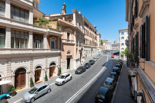 a city street with cars parked on the side of the road at Hotel Hiberia in Rome
