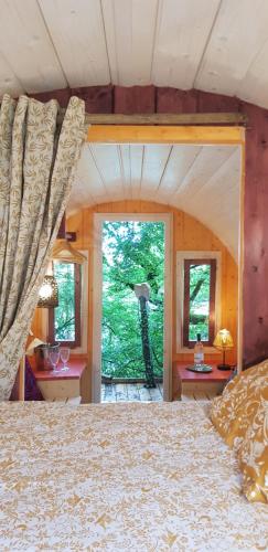 a bedroom with a large bed in a house at Les Robinsonades in Couladère