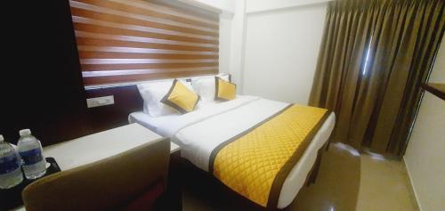 a hotel room with a bed and a couch at K Grandeur Hotels in Cochin