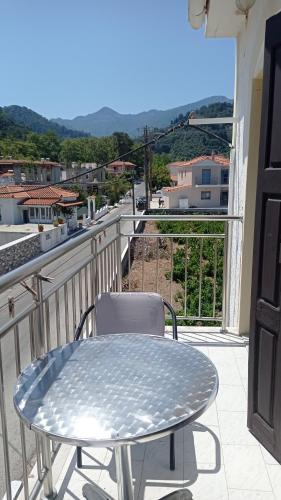 a table and a chair on a balcony with a view at Hotel Apartment Agios Konstantinos in Ágios Konstantínos
