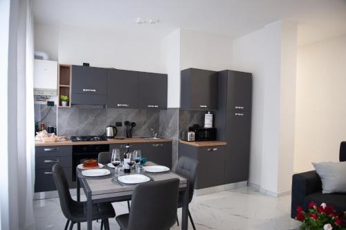 a kitchen with a table and chairs in a kitchen at Nuova Arte - Dal Lago di Como allo Stadio in Como