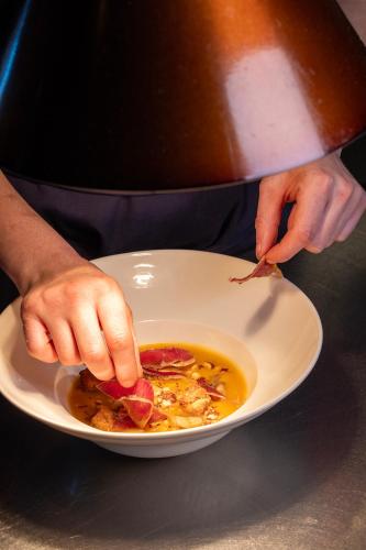 a person eating a plate of food with a bowl of food at Hôtel Spa Restaurant Villa Castellane in Gréoux-les-Bains