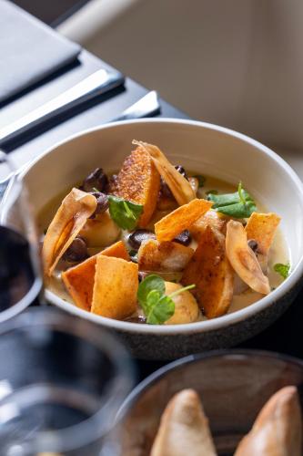 a bowl of food sitting on a table at Hôtel Spa Restaurant Villa Castellane in Gréoux-les-Bains