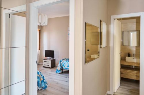 a room with a bed and a bathroom with a mirror at Vista Apartment Bardolino in Bardolino