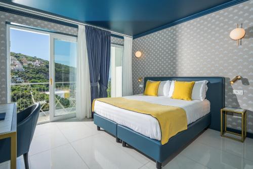 a bedroom with a bed and a large window at Hotel Mary in Vico Equense