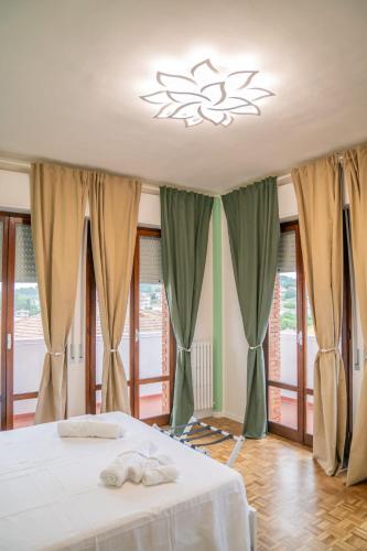 a bedroom with a bed with two towels on it at Vento del Conero in Sirolo
