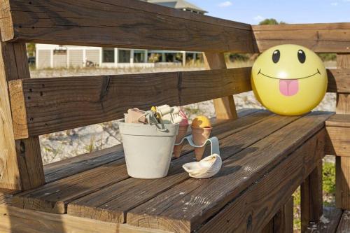 a bench with a bucket and a smiley face on it at Sun&Fun - Oceanfront, Quiet beach, Arcade games in Indian Pass