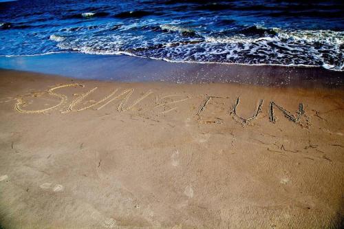 a sign written in the sand on the beach at Sun&Fun - Oceanfront, Quiet beach, Arcade games in Indian Pass